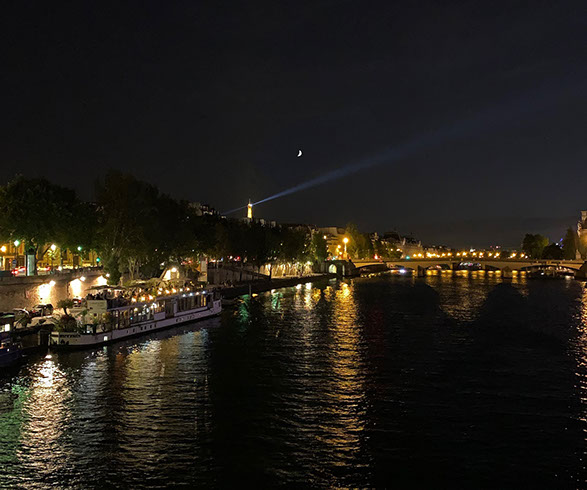 View of the Seine and the Eiffel Tower at night.